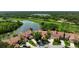 Stunning aerial view of a home on the golf course with a picturesque lake and verdant green landscape at 4472 Calle Serena, Sarasota, FL 34238