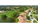 Lovely red-tiled roof home in a serene community next to a golf course, bordering a tranquil lake at 4472 Calle Serena, Sarasota, FL 34238