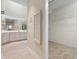 Hallway leading to a bright bathroom, and a walk-in closet at 4472 Calle Serena, Sarasota, FL 34238