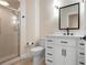Bathroom featuring a walk-in shower and a vanity with contemporary fixtures and finishes at 4472 Calle Serena, Sarasota, FL 34238