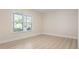 Bedroom featuring a large window, wood-look flooring, and neutral paint at 4472 Calle Serena, Sarasota, FL 34238