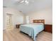Vaulted bedroom with light-colored wood-look flooring and an ensuite bathroom at 4472 Calle Serena, Sarasota, FL 34238