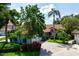 Aerial view of the property showcasing lush landscaping and a well-maintained home with a red tile roof at 4472 Calle Serena, Sarasota, FL 34238