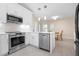 Modern kitchen featuring stainless steel appliances, quartz countertops, and white cabinets at 4472 Calle Serena, Sarasota, FL 34238