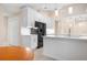 Bright kitchen with white cabinetry, stainless steel appliances, and stone countertops at 4472 Calle Serena, Sarasota, FL 34238