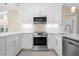 Bright, updated kitchen with modern stainless steel appliances and sleek white cabinetry at 4472 Calle Serena, Sarasota, FL 34238