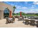 Relaxing outdoor patio with cozy seating, umbrellas, and golf course views for an inviting space at 4472 Calle Serena, Sarasota, FL 34238