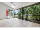 Screened patio with a view of lush landscaping and lake at 4472 Calle Serena, Sarasota, FL 34238