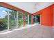 Enclosed patio boasts serene lake views, tile flooring, and a ceiling fan at 4472 Calle Serena, Sarasota, FL 34238