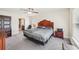Comfortable bedroom with a traditional style bed, soft carpet, and natural light at 4610 Clarke St, North Port, FL 34286