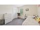 Cozy bedroom with gray carpet, dresser, and window offering natural light at 4610 Clarke St, North Port, FL 34286