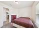 Bedroom with a comfortable bed, soft carpet, and a window to let in natural light at 4610 Clarke St, North Port, FL 34286