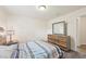 Cozy bedroom featuring a comfortable bed, natural light, and stylish wooden dresser at 4610 Clarke St, North Port, FL 34286