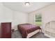 Comfortable bedroom with soft carpet, a dresser, and a window overlooking the yard at 4610 Clarke St, North Port, FL 34286