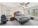 Bedroom with a large bed, ceiling fan, and windows providing ample natural light at 4610 Clarke St, North Port, FL 34286