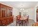 Elegant dining room with a chandelier, a large hutch, and plenty of space for Gathering gatherings at 4610 Clarke St, North Port, FL 34286