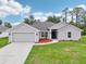 Charming home with a well-maintained lawn, walkway, and attached two-car garage at 4610 Clarke St, North Port, FL 34286