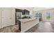 Bright kitchen with a granite island, stainless steel appliances, and dark cabinetry at 4610 Clarke St, North Port, FL 34286