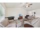 Expansive living room featuring neutral tones, tile flooring, comfortable seating, and abundant natural light at 4610 Clarke St, North Port, FL 34286