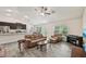 Open-concept living room with modern tile flooring, comfortable seating, and views of the adjacent kitchen area at 4610 Clarke St, North Port, FL 34286