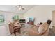 Spacious living room with tile floors, comfortable seating, and large windows offering plenty of natural light at 4610 Clarke St, North Port, FL 34286