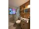 Quirky bathroom with glass block shower, bamboo accent wall, and vintage-style fixtures at 5011 Elfrida Ave, Sarasota, FL 34235