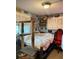 Cluttered bedroom with eclectic decor, a large bed, and an abundance of personal items at 5011 Elfrida Ave, Sarasota, FL 34235