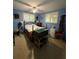 Cozy blue bedroom with two windows, simple furnishings, and a ceiling fan at 5011 Elfrida Ave, Sarasota, FL 34235