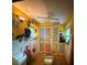 Bright yellow eat-in kitchen with retro appliances, ample storage, and flamingo decorations at 5011 Elfrida Ave, Sarasota, FL 34235