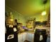 Compact kitchen with vintage blue cabinets, black appliances, and tiled backsplash at 5011 Elfrida Ave, Sarasota, FL 34235