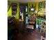 Eclectic living room featuring bright green walls, unique shelving, and comfortable seating at 5011 Elfrida Ave, Sarasota, FL 34235