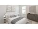 Elegant bedroom with a comfortable bed, stylish furnishings, and plenty of natural light at 5050 Rocky Coast Pl, Palmetto, FL 34221