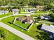 Lovely aerial view of the fenced in property showing a large, well maintained grassy yard, and mature trees surrounding the home at 5200 Malaga Ave, Sarasota, FL 34235