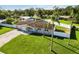 Aerial view of home featuring a green lawn, fenced backyard, and palm trees at 5200 Malaga Ave, Sarasota, FL 34235