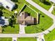 Aerial view of the home with a well-maintained yard and driveway at 5200 Malaga Ave, Sarasota, FL 34235