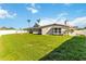 Large backyard with lush grass, privacy fence, and mature trees at 5200 Malaga Ave, Sarasota, FL 34235