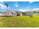 Backyard features a green lawn, a fire pit and privacy fence at 5200 Malaga Ave, Sarasota, FL 34235