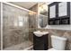 Bathroom featuring glass-door shower, a sink with vanity and storage, with neutral modern colors and design at 5200 Malaga Ave, Sarasota, FL 34235