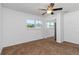 This bright carpeted bedroom features a mirrored closet and a ceiling fan at 5200 Malaga Ave, Sarasota, FL 34235
