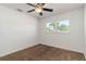 A bright bedroom is carpeted and has one window and a ceiling fan at 5200 Malaga Ave, Sarasota, FL 34235