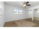 Bedroom featuring carpet, a ceiling fan, natural light from the window, and mirrored closet doors at 5200 Malaga Ave, Sarasota, FL 34235