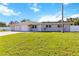 A lovely one-story home with a two-car garage, a well-kept lawn and mature palm trees at 5200 Malaga Ave, Sarasota, FL 34235