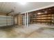 Spacious garage with ample storage shelving and rolling garage door at 5200 Malaga Ave, Sarasota, FL 34235