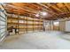Spacious garage features shelving for storage, exposed ceiling beams, and cement flooring at 5200 Malaga Ave, Sarasota, FL 34235