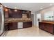 Elegant kitchen with granite countertops, stainless steel appliances, and dark wood cabinetry at 5200 Malaga Ave, Sarasota, FL 34235