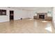 Spacious living room with a stone fireplace and open access to the kitchen area at 5200 Malaga Ave, Sarasota, FL 34235