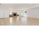 Spacious living room with a stone fireplace, tile flooring, and abundant natural light at 5200 Malaga Ave, Sarasota, FL 34235