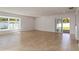 Open living room with large windows, tile flooring and sliding glass doors at 5200 Malaga Ave, Sarasota, FL 34235