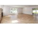 Bright and airy living room with a stone fireplace, and sliding glass doors to the outdoors at 5200 Malaga Ave, Sarasota, FL 34235