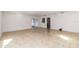 A well-lit living room featuring tile flooring, with sliding doors to the patio at 5200 Malaga Ave, Sarasota, FL 34235